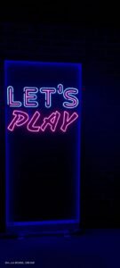 blue signage with a pink led signage , and a writing lets play