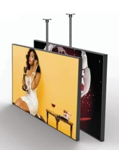two signages one is showing a girl in white dress calling through a cell phone in a yellow background and one is behind the yellow screen