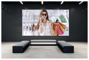 a young beautiful lady , and she is coming from shopping with shopping bags , screening in a digital screens