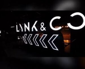 white colored lynk & co signage in a dark exhibition and event room